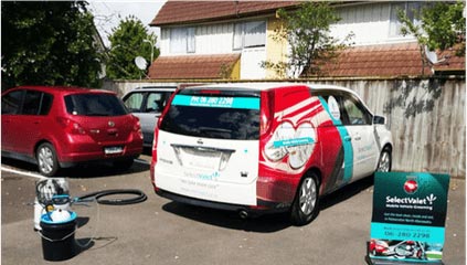 SelectValet van parked with cleaning equipment outside and a footpath sign